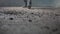 The cinematic close-up shot of an officer walking on debris and trash.