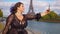 Cinematic footage of a young woman wearing fashionable clothes having fun in Paris at the eiffel tower park and streets