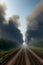 Cinematic image of air pollution in air through industrial activities with railway track leading to it, created with