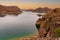 Cinematic lake surrounded by red cliffs in Provincia de Mendoza, Argentina