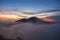 A cinematic magical landmark view of kintamani volcano peak and golden sky from the top of the Mount Batur during the sunrise with