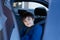 Cinematic portrait boy siting in safety car seat looking at camera with smiling face,Child sitting in the back passenger seat with