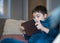 Cinematic portrait happy kid watching cartoon on tablet, Candid shot cute boy playing game online with friends on internet, Cozy