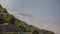 Cinematic POV shot of tourists in raincoats walking up the ladder at epic beautiful Niagara Falls waterfall on sunny day