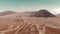 Cinematic shot aerial view of beautiful Mount Bromo volcano with desert in East Java