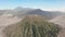 Cinematic shot aerial view of beautiful Mount Bromo volcano peak with desert in East Java