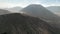 Cinematic shot aerial view of Mount Bromo crater edge with active volcano smoke in East Java