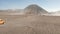 Cinematic shot aerial view of tour jeep cruise at beautiful Mount Bromo volcano with desert in East Java