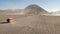 Cinematic shot aerial view of tour jeep cruise at beautiful Mount Bromo volcano with desert in East Java