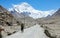 Cinematic shot of travelers hiking towards breathtaking windswept Mount Everest.