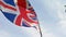 Cinematic shot. United Kingdom flag waving in the wind