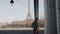 Cinematic side view shot, elegant happy beautiful woman walking along Paris street, sunny Eiffel Tower view slow motion.