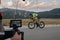 Cinematographer taking action shot of triathlon bike athlete