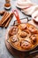 Cinnabon cinnamon rolls buns with pumpkin, nut, caramel and sugar cream iced. Top view. Sweet Homemade Pastry christmas baking.