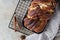 Cinnamon babka or swirl brioche bread on black metal grille. Cinnamon roll bread. European Easter sweet bread. Homemade pastry for