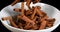 Cinnamon, cinnamomum zeylanicum, spice falling against Black Background, Slow Motion