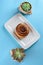 Cinnamon Danish Swirl-classic buttery danish pastry roll and two small succulent plant.