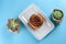 Cinnamon Danish Swirl-classic buttery danish pastry roll and two small succulent plant.