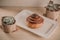 Cinnamon Danish and two small succulent plant.