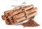Cinnamon dried bark strips and cinnamon powder, sweet-smelling brown substance used in cooking, isolated on white background