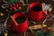 Cinnamon mulled wine in two red cups. Christmas anticipation concept, view from above