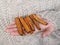 Cinnamon pods in the hands of a girl. A woman in a knitted wool sweater holds cinnamon in her hands. Cozy atmosphere