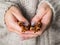 Cinnamon pods in the hands of a girl. A woman in a knitted wool sweater holds cinnamon in her hands. Cozy atmosphere