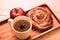 Cinnamon Roll, apple and tea wooden backgroud