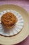 Cinnamon rolls with Lotus BIscoff crumbs topping on a white and bamboo plate