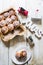 Cinnamon rolls with sugar icing  ready to be eaten for christmas holiday, top view over a white wooden    background  with a