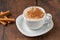 Cinnamon sprinkled salep in a white cup on wooden table