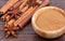 Cinnamon sticks with anise star and bowl with cinnamon powder