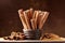 Cinnamon sticks and powder on brown dust background. Aromatic spice.