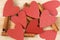 Cinnamon sticks and red hearts on a wooden background