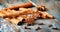 Cinnamon sticks, star anise and clove, star anise, seasoning, on a diffused background, blue old paint, cinnamon flavor, food