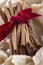 Cinnamon sticks tied with a red ribbon in wrapped paper