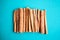 Cinnamon sticks on the turquois background, flat lay