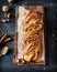 Cinnamon twisted loaf bread or babka on a dark wooden background