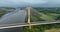 A circle around a beautiful bridge. A massive cable-stayed bridge against a backdrop of green fields