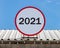 A Circle billboard with number 2021, is installed on a roof.