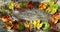 A circle of colourful autumn leaves on a wooden background