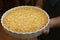 The circle dish of cracker crust in hand