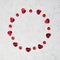 Circle made of hearts and red crystals on marble background with copy space, happy valentine`s day, mother`s day, flat lay, top