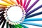 Circle or rainbow swirl of colored pencils on a white background on the left, copy space, mock up, LGBT symbol