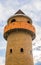 Circle Tower made of orange brick and blue sky background