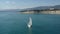 Circling aerial shot of sailboat cruising the sea.
