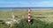 Circling Around Ameland Lighthouse, Dunes in the Background - Ameland, The Netherlands, 4K Drone Footage