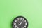 circular black clock green wall backdrop