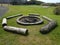 circular fire pit with charcoal and logs