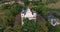 circular flight and aerial panoramic view overlooking the old orthodox church or historic buildings in forest